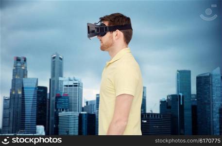 3d technology, virtual reality, entertainment and people concept - young man with virtual reality headset or 3d glasses over singapore city skyscrapers background