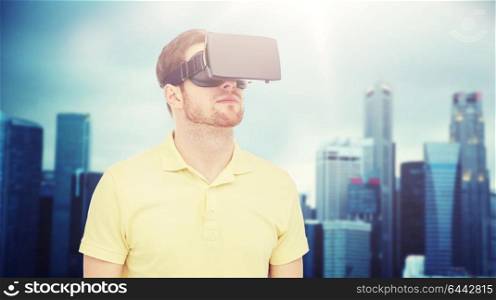 3d technology, virtual reality, entertainment and people concept - young man with virtual reality headset or 3d glasses over singapore city skyscrapers background. man in virtual reality headset or 3d glasses