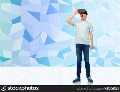 3d technology, virtual reality, entertainment, cyberspace and people concept - amazed young man with virtual reality headset or 3d glasses over low poly background