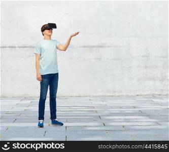 3d technology, virtual reality, entertainment, cyberspace and people concept - happy man with virtual reality headset or 3d glasses playing game and holding something on palm over street background