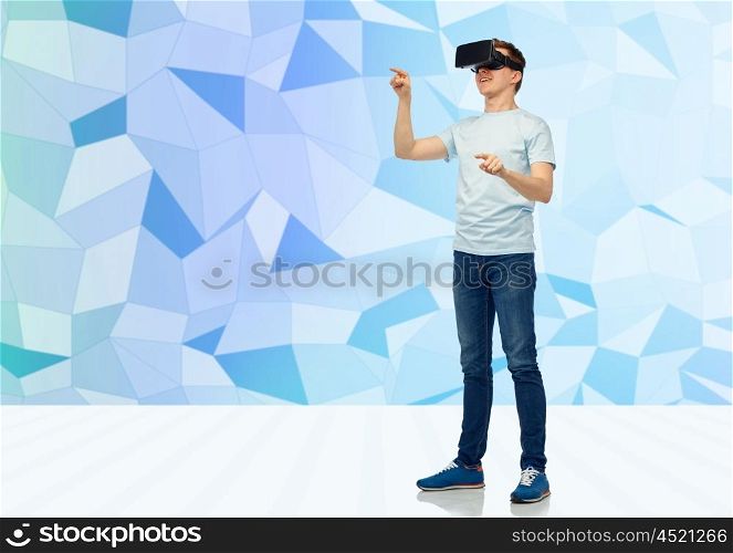 3d technology, virtual reality, entertainment, cyberspace and people concept - happy young man with virtual reality headset or 3d glasses playing game and touching something over low poly background