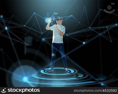 3d technology, virtual reality, entertainment, cyberspace and people concept - happy young man with virtual reality headset or 3d glasses and projection over dark background