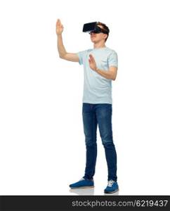 3d technology, virtual reality, entertainment, cyberspace and people concept - happy young man with virtual reality headset or 3d glasses playing game and touching something