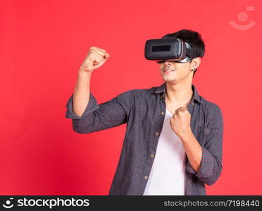 3d technology, virtual reality, entertainment, cyberspace and people concept - happy young caucasian handsome man with virtual reality headset or 3d glasses playing game and catching something