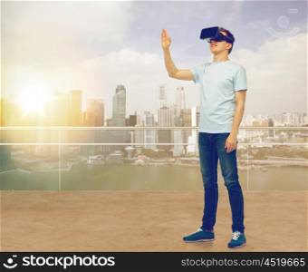3d technology, virtual reality, entertainment, cyberspace and people concept - man with virtual reality headset or 3d glasses playing game and touching something over singapore skyscrapers background