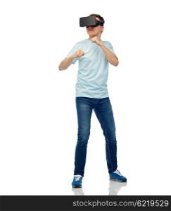 3d technology, virtual reality, entertainment, cyberspace and people concept - young man with virtual reality headset or 3d glasses playing game and fighting