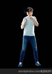 3d technology, virtual reality, entertainment, cyberspace and people concept - young man with virtual reality headset or 3d glasses playing game and fighting