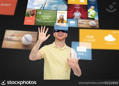 3d technology, virtual reality, entertainment, media and people concept - happy young man in virtual reality headset or 3d glasses playing game over black background with internet applications