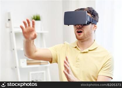 3d technology, virtual reality, gaming, entertainment and people concept - amazed young man with virtual reality headset or 3d glasses playing game