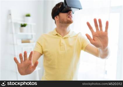 3d technology, virtual reality, gaming, entertainment and people concept - close up of happy young man with virtual reality headset or 3d glasses playing videogame at home