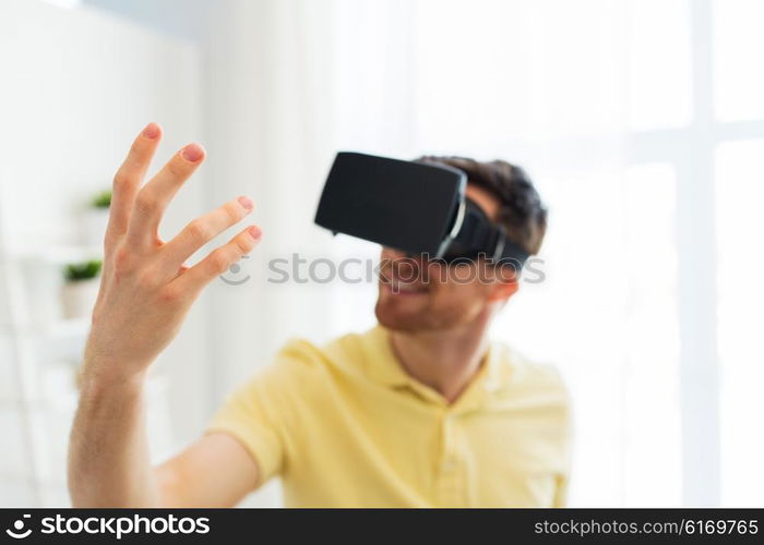 3d technology, virtual reality, gaming, entertainment and people concept - close up of young man with virtual reality headset or 3d glasses playing videogame at home