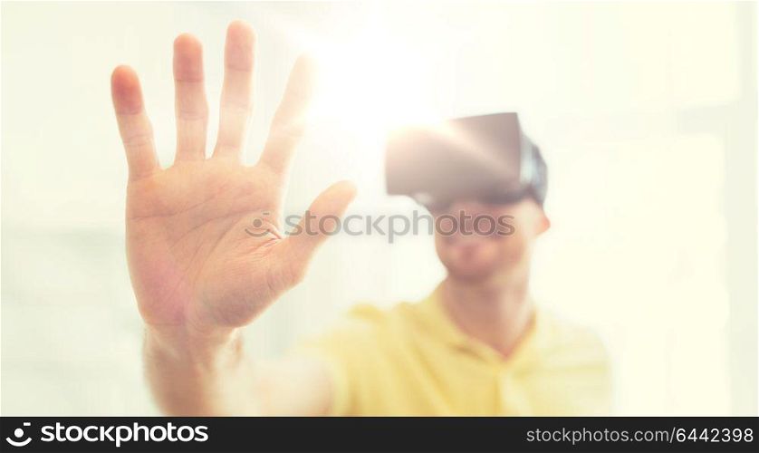 3d technology, virtual reality, gaming, entertainment and people concept - close up of happy young man with virtual reality headset or 3d glasses playing videogame at home. young man in virtual reality headset or 3d glasses