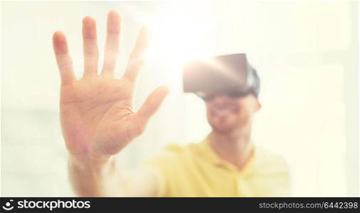 3d technology, virtual reality, gaming, entertainment and people concept - close up of happy young man with virtual reality headset or 3d glasses playing videogame at home. young man in virtual reality headset or 3d glasses