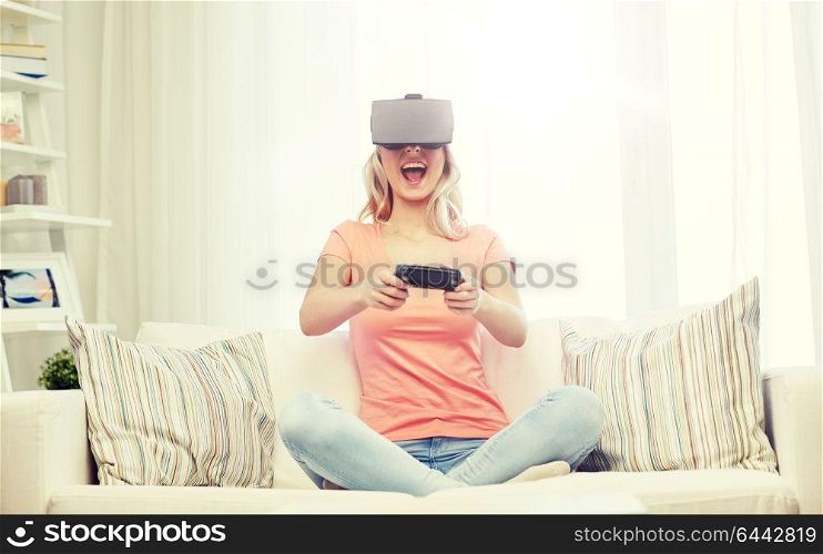 3d technology, virtual reality, gaming, entertainment and people concept - happy young woman with virtual reality headset or 3d glasses playing video game with controller gamepad at home. woman in virtual reality headset with controller