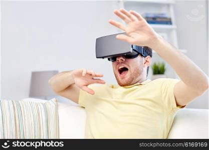 3d technology, virtual reality, gaming, entertainment and people concept - scared young man with virtual reality headset or 3d glasses playing game