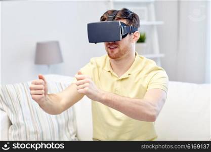 3d technology, virtual reality, gaming, entertainment and people concept - young man with virtual reality headset or 3d glasses playing racing videogame at home