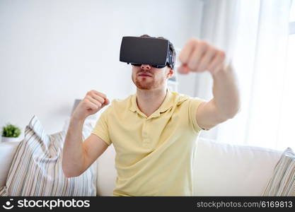 3d technology, virtual reality, gaming, entertainment and people concept - young man with virtual reality headset or 3d glasses playing combat game and fighting