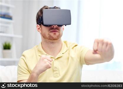 3d technology, virtual reality, gaming, entertainment and people concept - young man with virtual reality headset or 3d glasses playing combat game and fighting