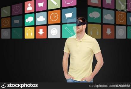 3d technology, virtual reality, multimedia, entertainment and people concept - happy young man in virtual reality headset or 3d glasses witj computer icons over black background