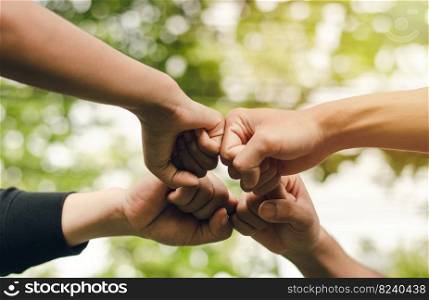 4 people join forces, the concept of hand-to-hand to create unity, group of people, hands, teamwork business group by reaching out in a circle The power of work is friendship with business colleagues.