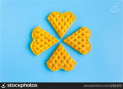 4 Pieces Waffle on Blue Pastel Background Minimalist Style. Heart shape waffle dessert in minimalist style for food and dessert category