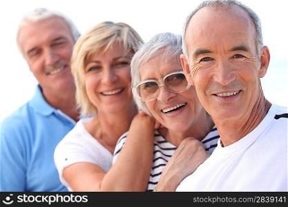 4 senior people laughing