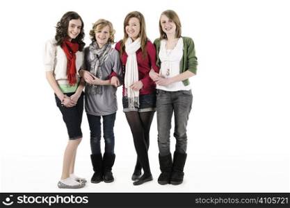 4 teenage girls standing on white smiling at camera