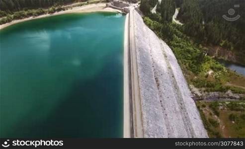 4K aerial shot of the dam of Bolboci Lake. A wonderful trip close to Sinaia one of the highest altitude mountain roads in Romania.