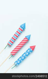 4th of july firework. USA flag style rockets on blue background top view. Independence day celebration firecrackers.