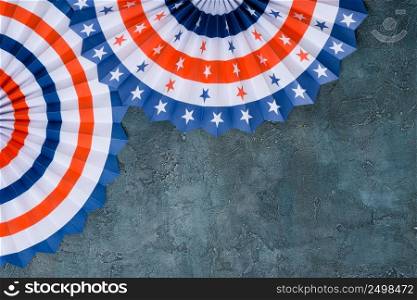 4th of July paper fan US flag color style on grunge rustic background flat lay.
