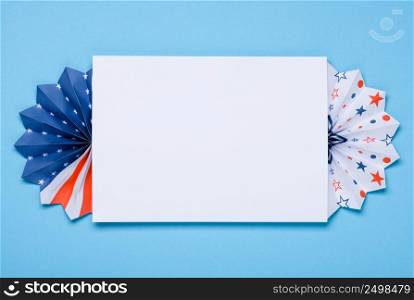 4th of July template. Paper fans stars USA Independence Day flag colors on blue background with copy-space.