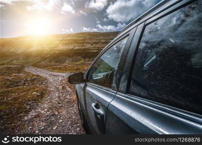 4WD SUV vehicle car running on gravel road with nature mountain landscape in Iceland. Adventure and extreme sport.