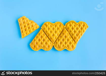 5 Pieces in Row Waffle on Blue Pastel Background Minimalist Style. Heart shape waffle dessert in minimalist style for food and dessert category