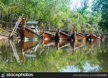 5 wooden boats parked in the canal