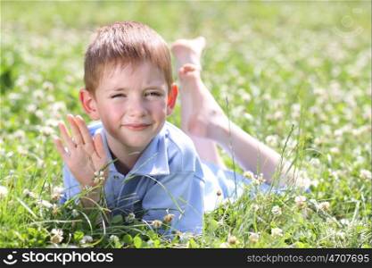 5 years old child lying on the grass.