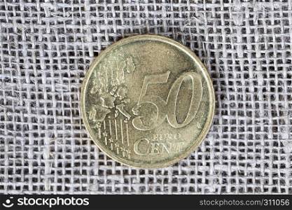 50 European center, half euro lies on a gray linen fabric.. 50 cents euro