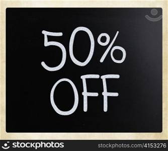 ""50% off" handwritten with white chalk on a blackboard"