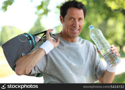 50 years old man drinking man after he did sport