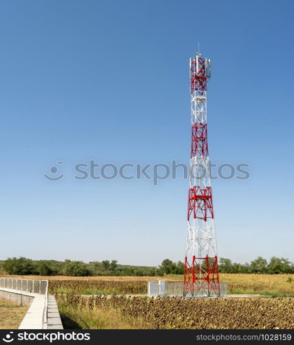 5G antenna for high speed internet distribution. 5G repeaters outside the city. Bright colours red and white.