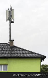 5G antennas on top of house. Antennas and transmitters on roof. High speed mobile internet concept.