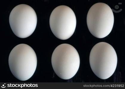 6 eggs isolated in 2 rows on black background