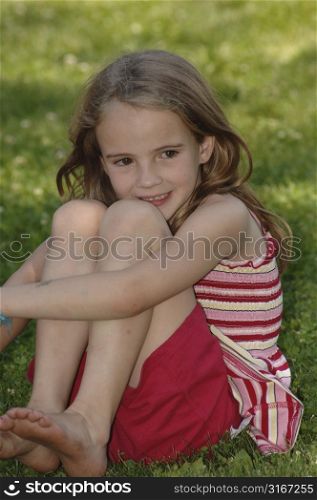 6 year old sitting on the grass