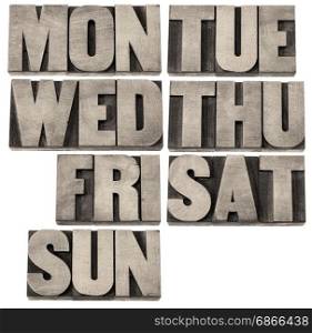 7 days of week (first 3 letter symbols) in isolated vintage wood letterpress printing blocks, black and white warm toned image