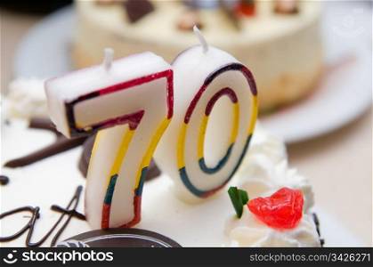 70 years old candles on a cream cake