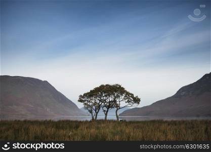 70909380 - beautiful foggy misty fall sunrise over countryside surrounding crummock water in lake district in england