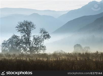 71426634 - beautiful foggy misty fall sunrise over countryside surrounding crummock water in lake district in england