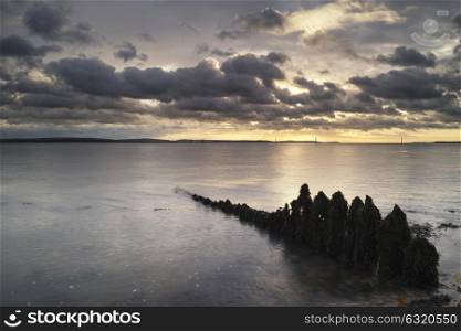 71945356 - beautiful sea landscape looking across solent to isle of wight in england with moody dramatic sunset sky