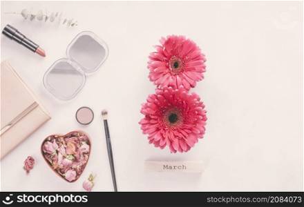 8 march inscription from gerbera flowers with cosmetics table