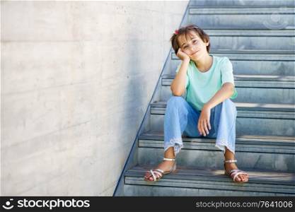 9-year-old girl posing happily on a staircase in the city.. 9-year-old girl posing happily on a staircase
