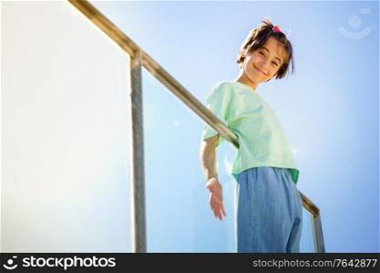 9-year-old girl posing happily on a staircase in the city.. 9-year-old girl posing happily on a staircase
